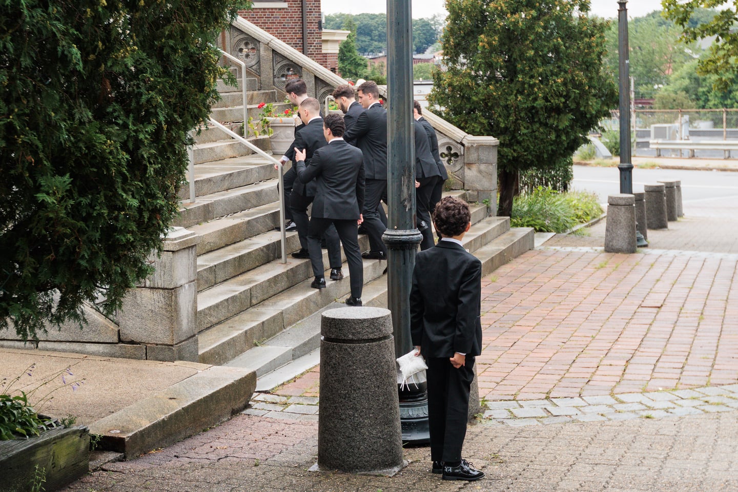 Two men in suits walk toward the church entrance.