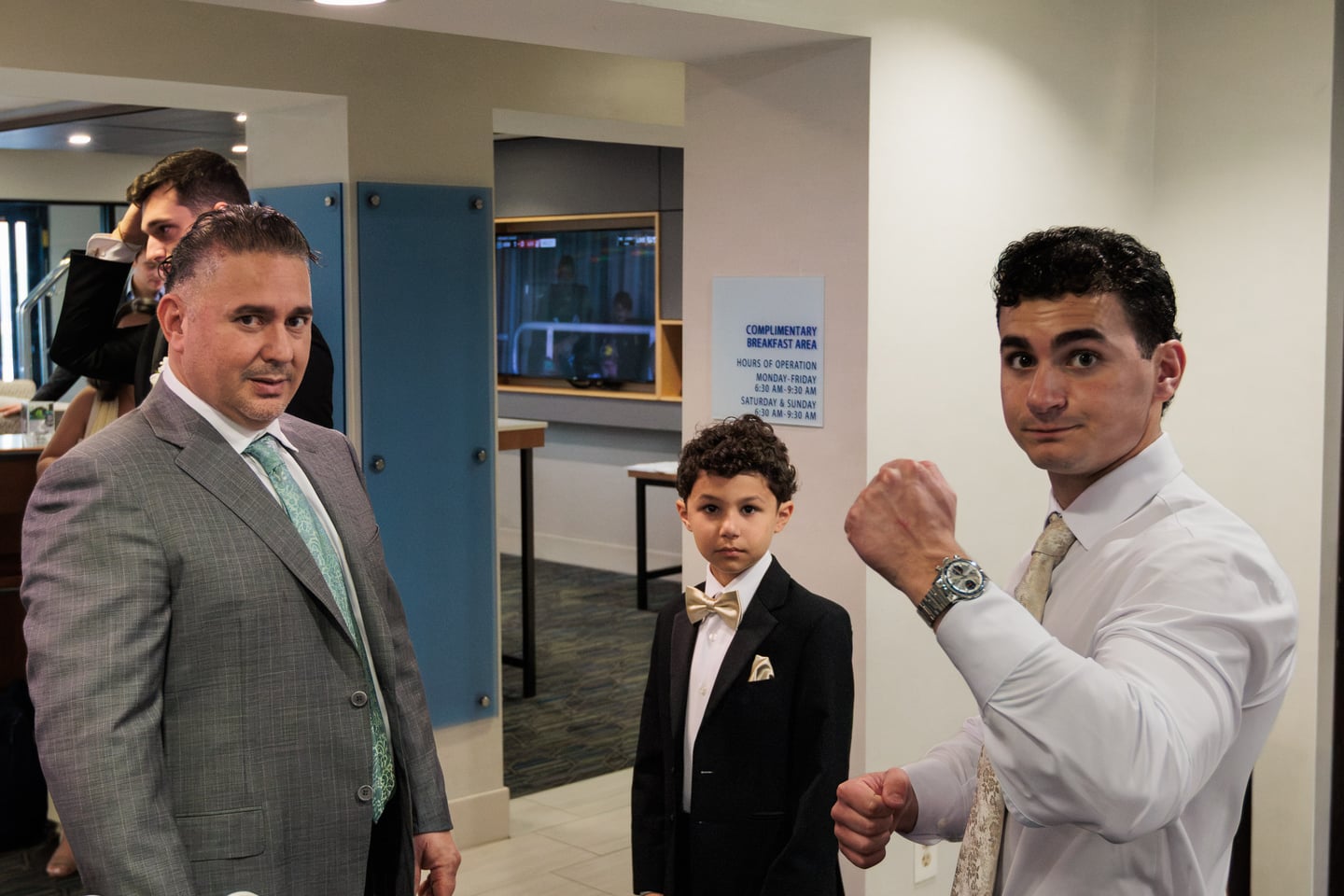 Three members of the wedding party talk together while getting ready.