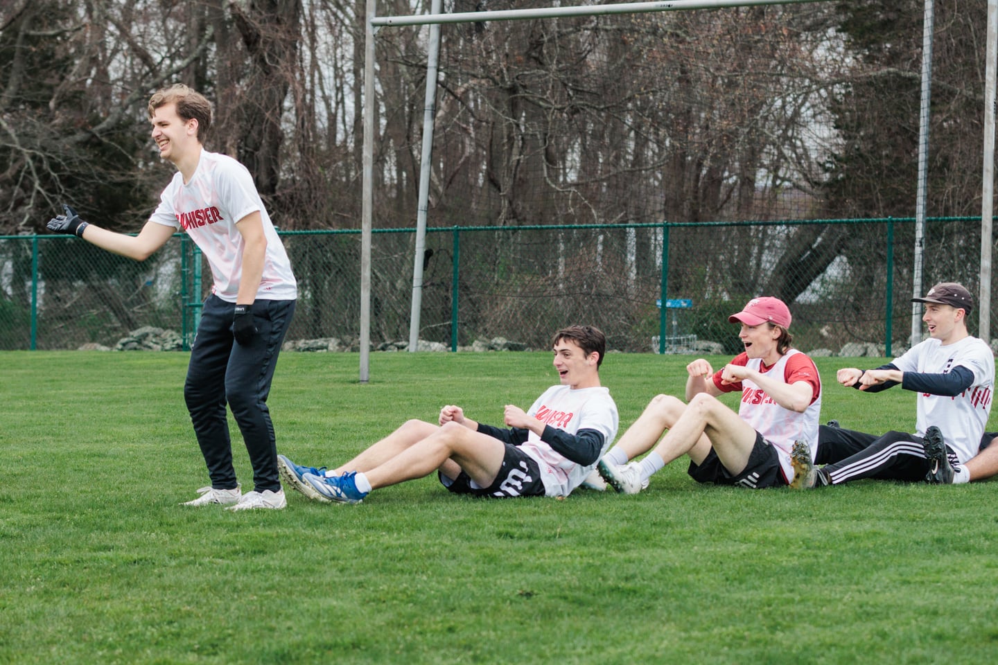 White-clad teammates cheer from the sideline between points.