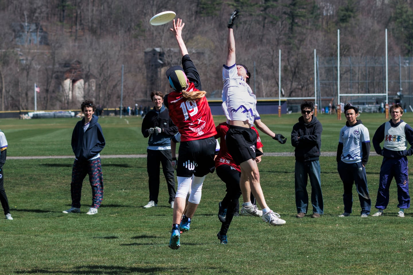 Several players converge beneath a contested disc.