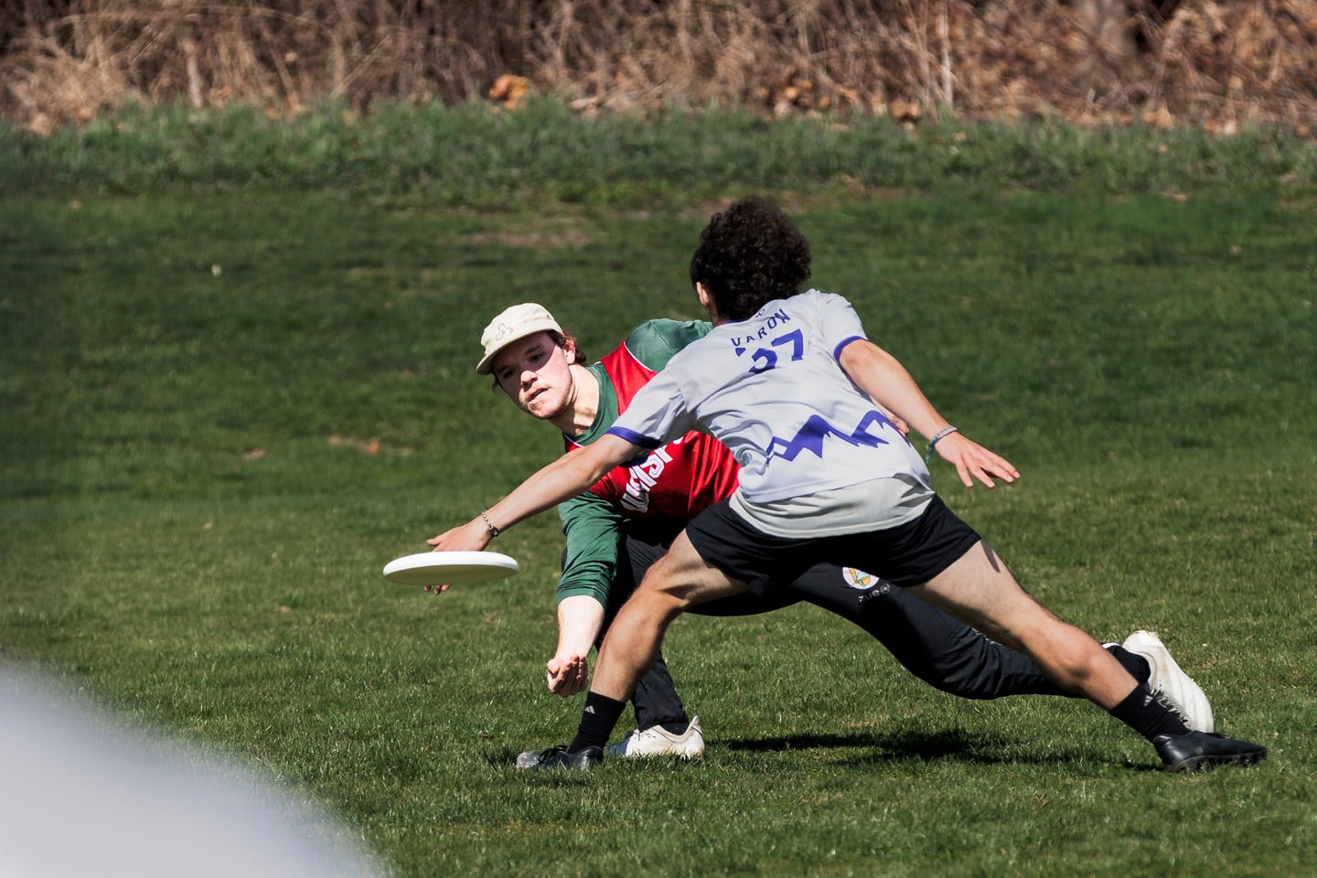 Red and gray-clad players battle for position near the ground.