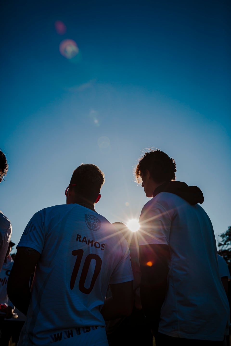 Backlit silhouette of a player in a jersey.