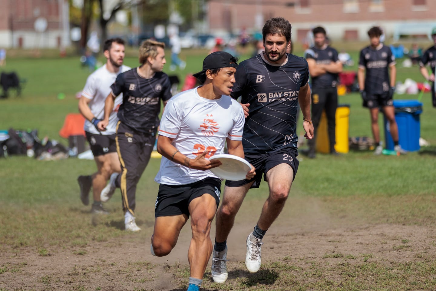 Player kicking up dust while running a cut.