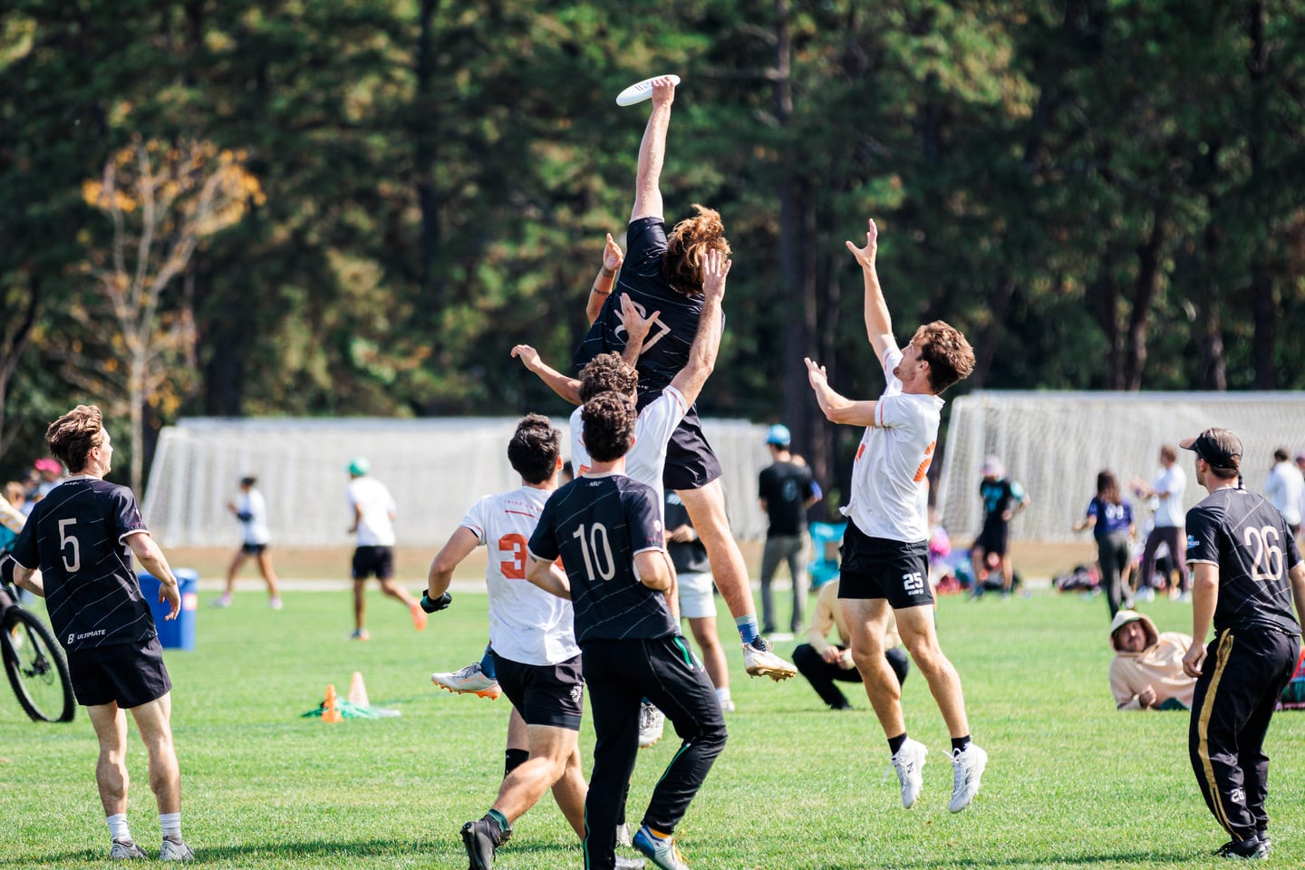 Athletes leaping in a group jump contest.