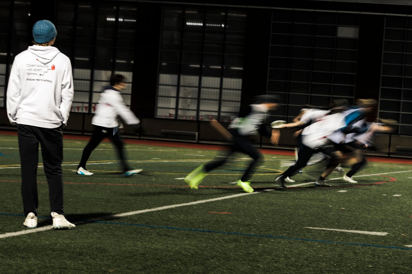 Motion blur of players under night lights.
