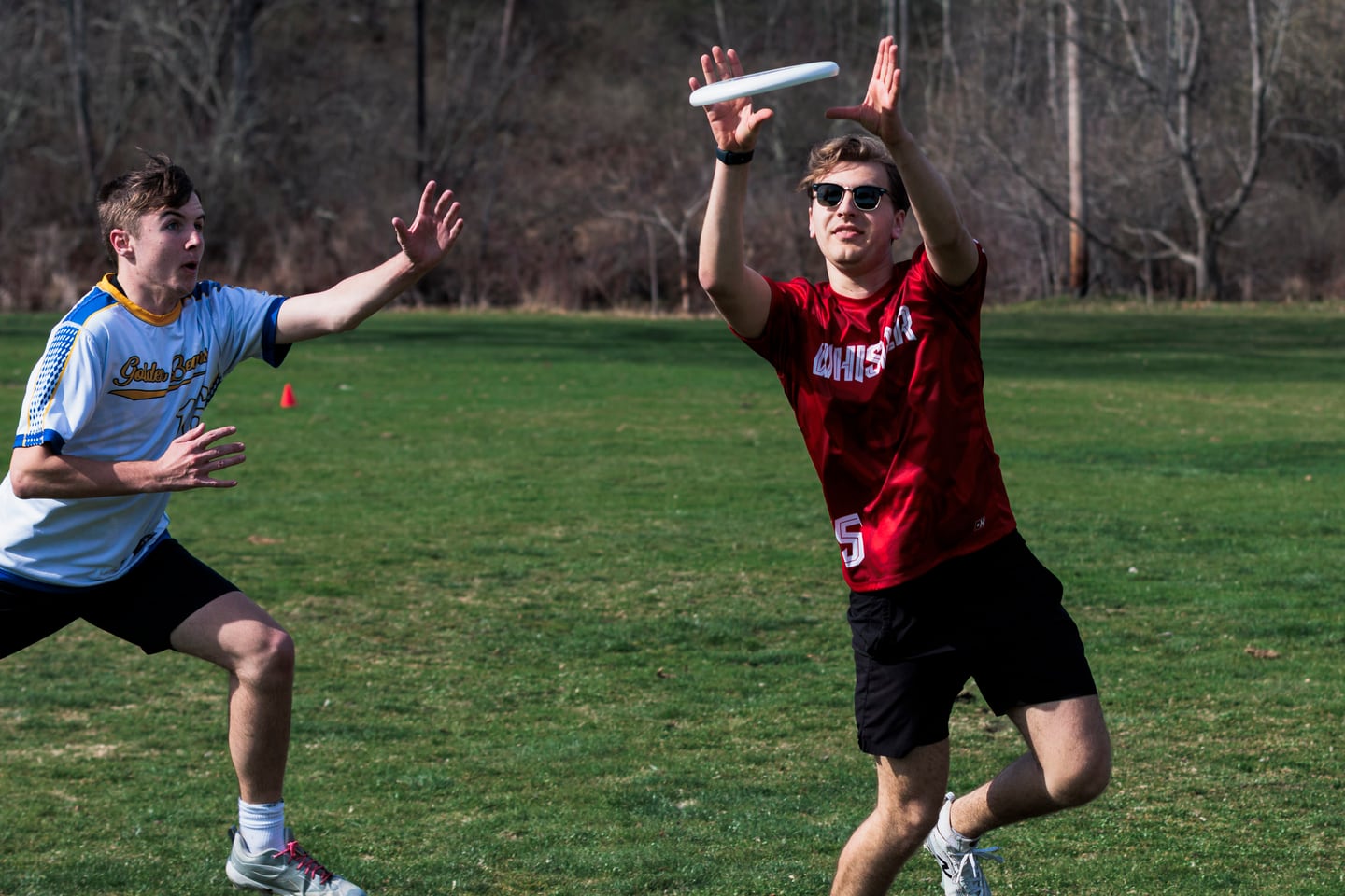 Reach for a red disc against a dark stadium backdrop.