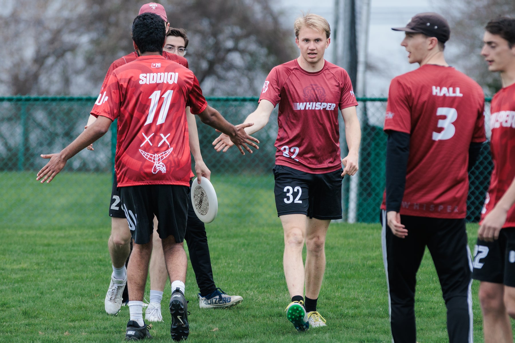 WPI Whisper players regroup together on the field between points.