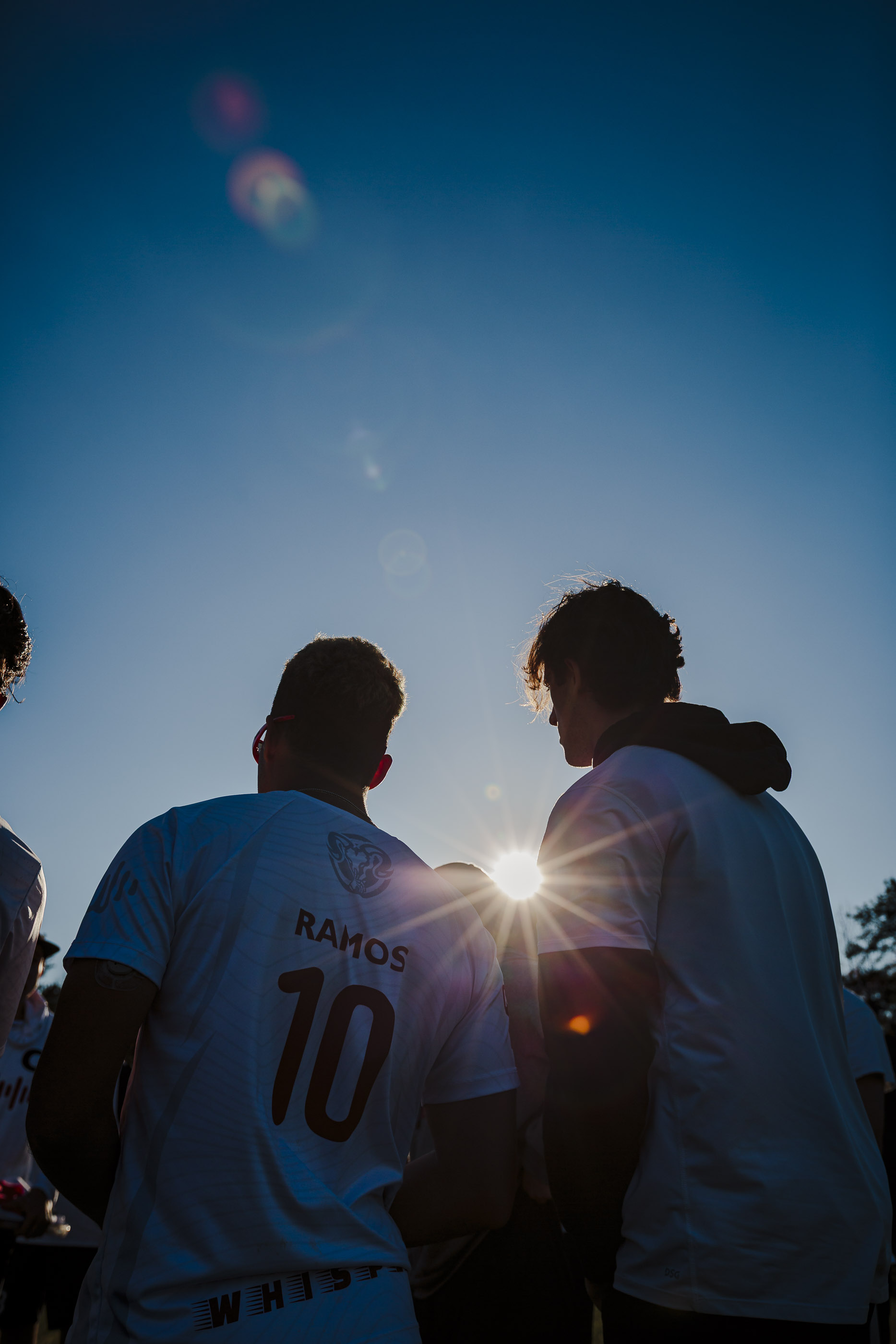 Backlit silhouette of a player in a jersey.
