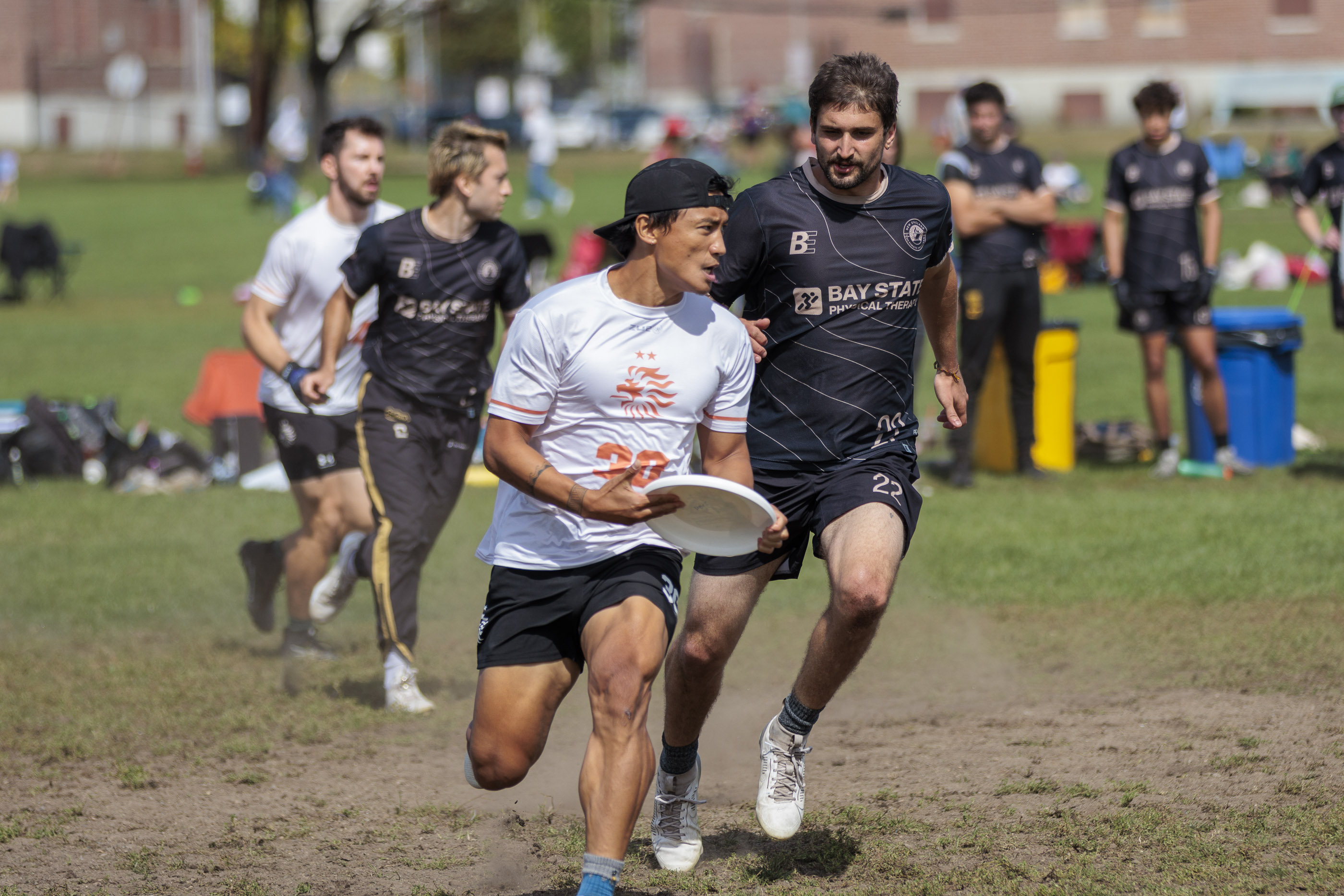 Player kicking up dust while running a cut.