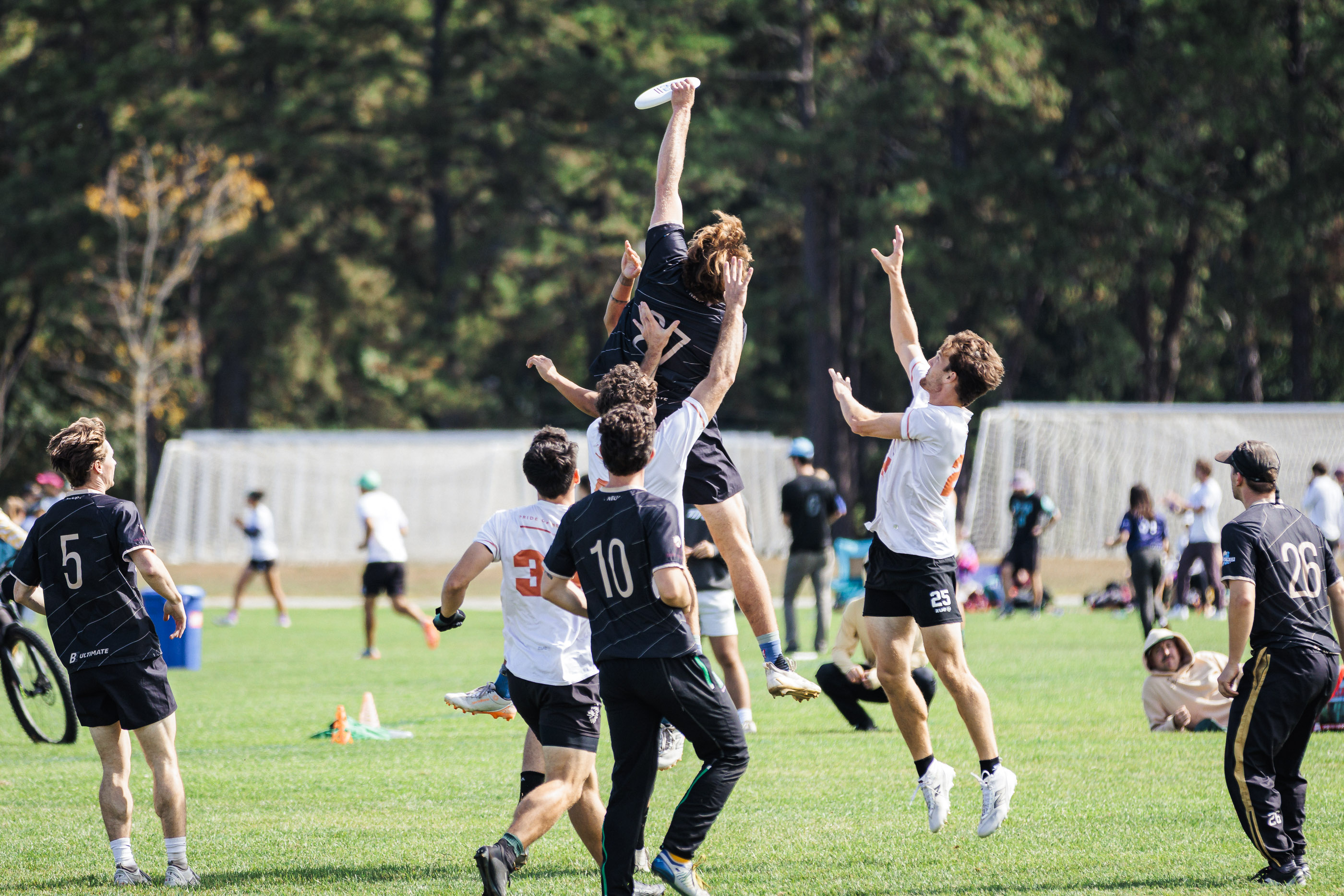Athletes leaping in a group jump contest.