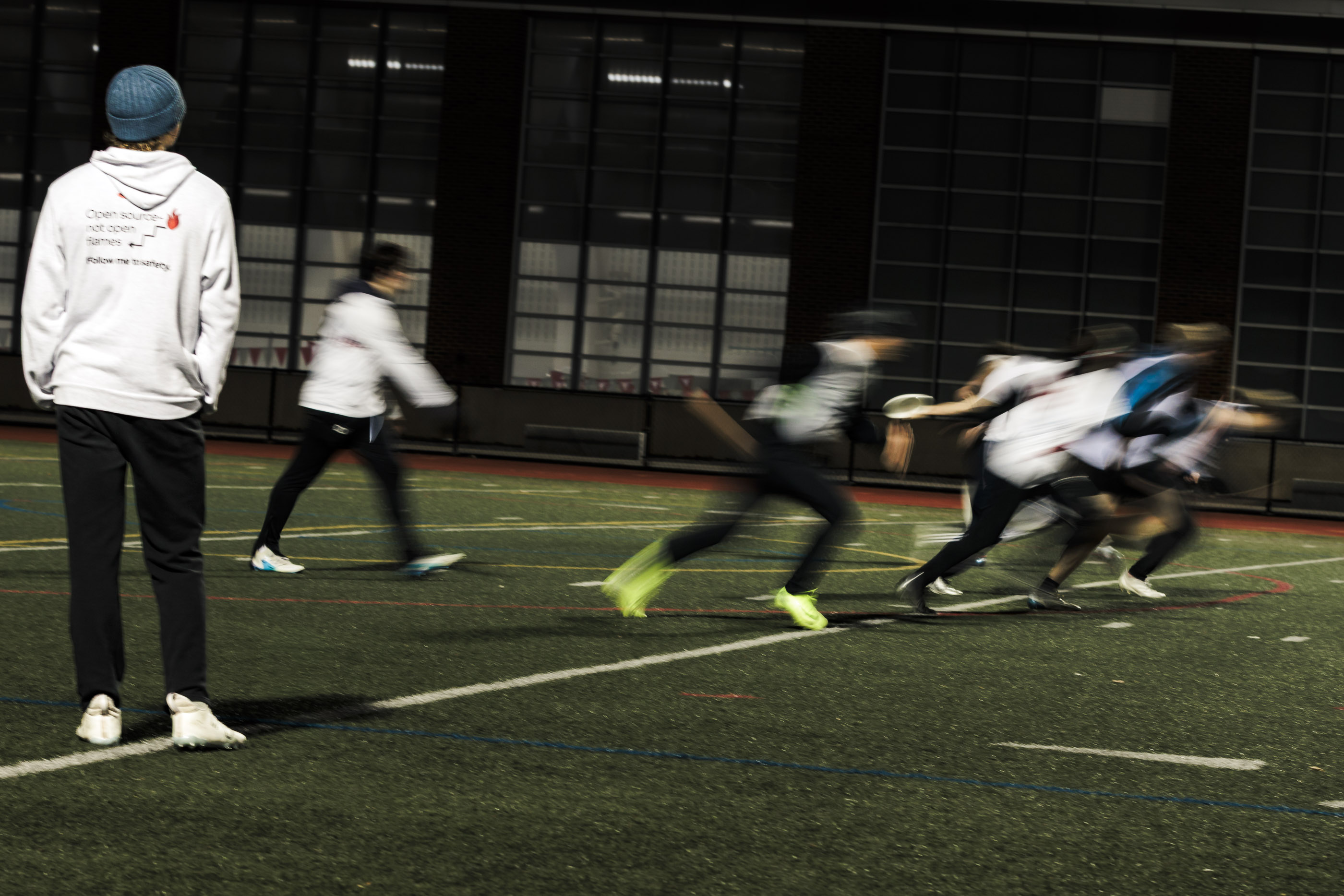 Motion blur of players under night lights.